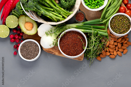 Assorted vegetables and cereal on gray background. Healthy food concept.