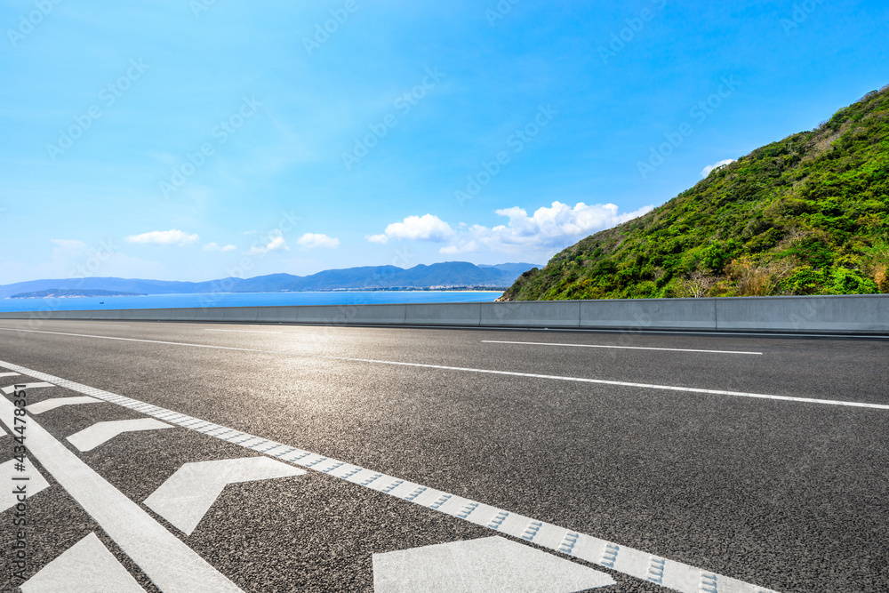 Mountain highway with blue sky and sea landscape.
