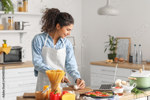 Young woman using laptop wh...