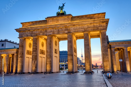 The Brandenburg Gate with the TV Tower in the back before sunrise, seen in Berlin, Germany