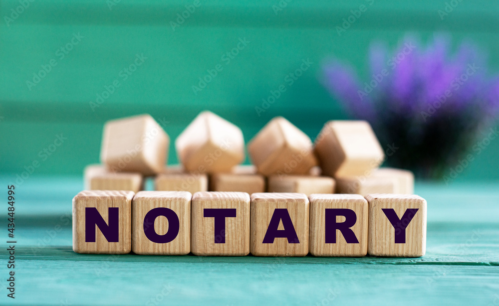 NOTARY - word on wooden cubes on a green background with lavender NOTARY - word on wooden cubes on a green background with lavender