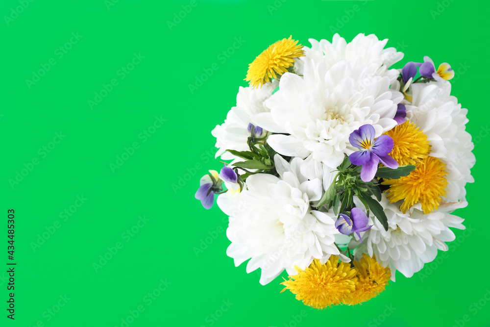 bouquet of flowers on a green background. view from above. copy space..