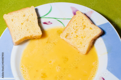 Cooking torrijas, a typical Spanish sweet fried toasts of sliced bread soaked in eggs and wine. Traditional dessert of Holy Week in Spain.