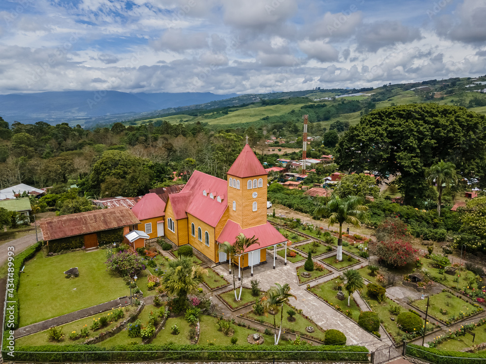 Beautiful aerial view of the Aquiares town and its iconic yellow church in Cartago Costa Rica