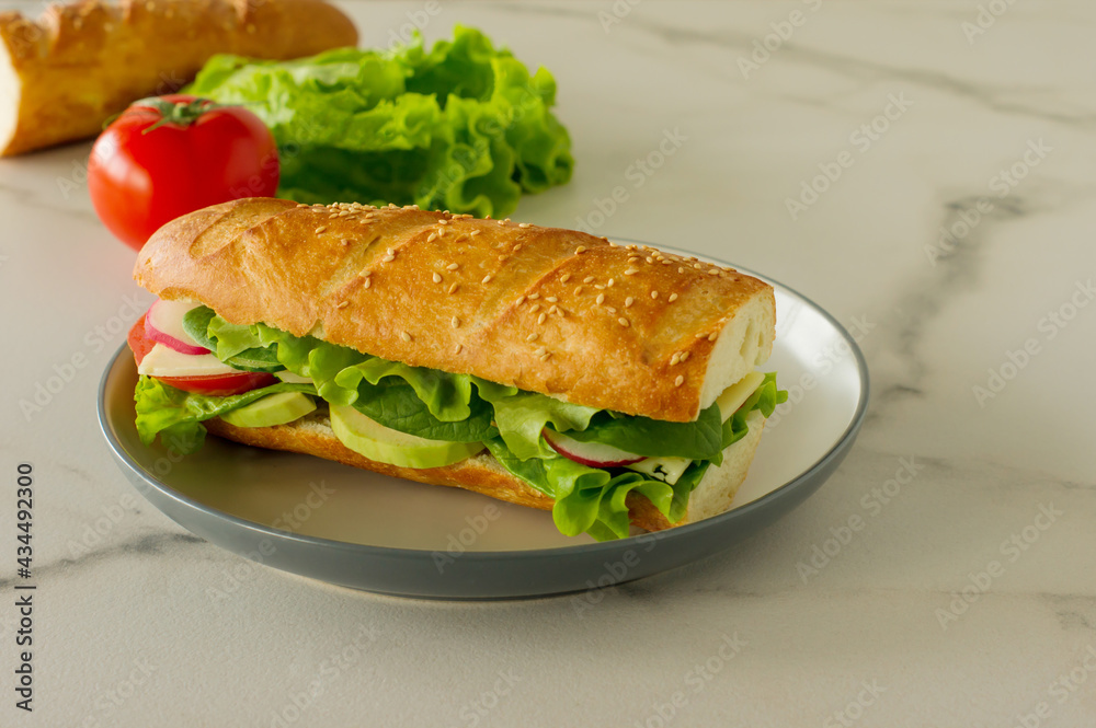whole grain long baguette vegan sandwich with lettuce, avocado, tomato and cheese. Healthy snack and food to go whole grain long baguette vegan sandwich with lettuce, avocado, tomato and cheese. Healthy snack and food to go