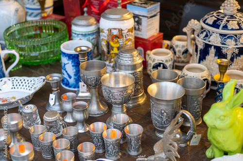 Assorted goblets and glasses on counter at market © Anton Gvozdikov