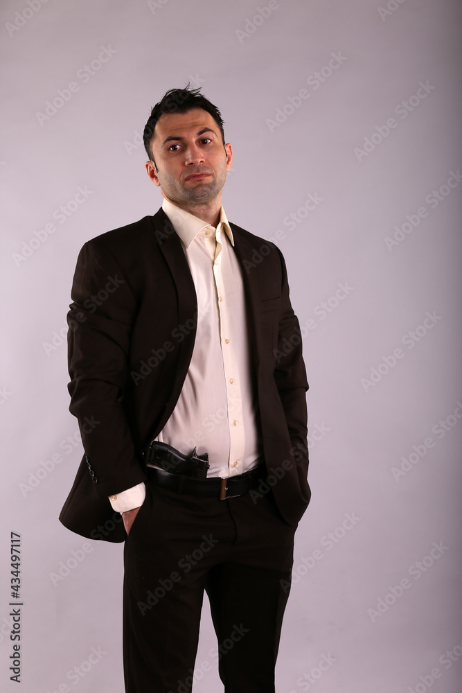 Fototapeta premium A man in jacket with a gun
