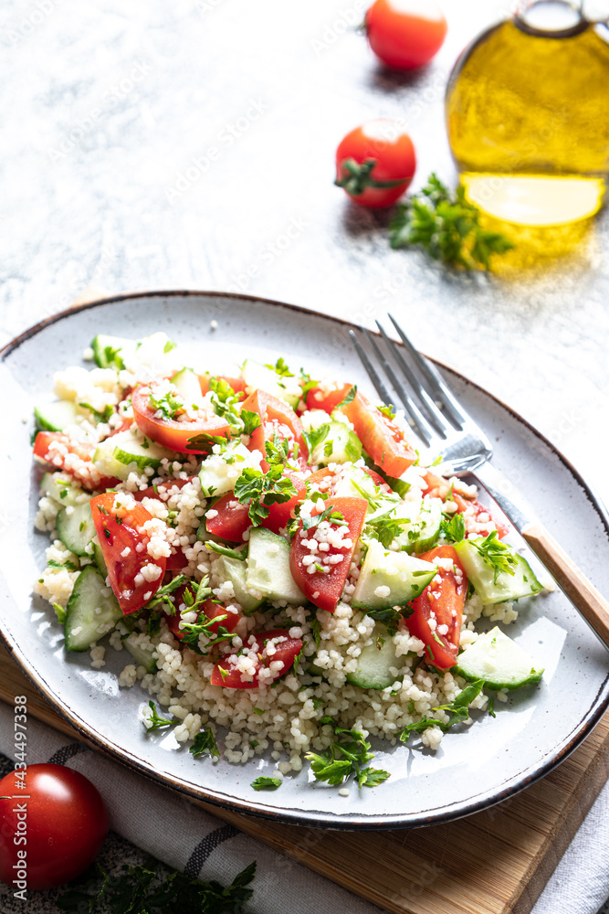 Traditional oriental salad Tabouleh. Tabule cous cous salad with vegetables. Tabbouleh with bulgur