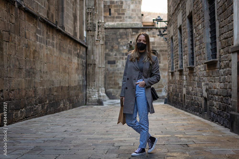 Young girl with casual style mask posing in the old town Young girl with casual style mask posing in the old town