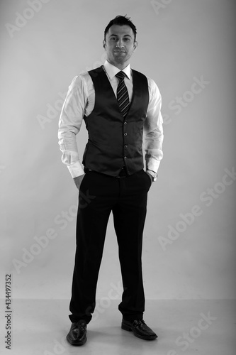 Bild auf Leinwand Black and white portrait of a man in white shirt and vest