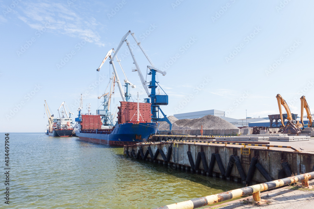 View of the industrial port in the Baltic Sea. There is a ships under load in the harbor. View of the industrial port in the Baltic Sea. There is a ships under load in the harbor.