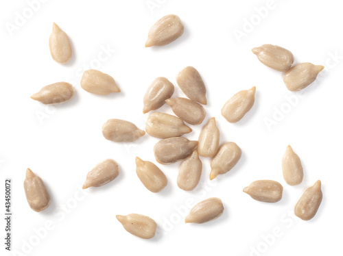 close up of peeled sunflower seeds isolated on white background, top view