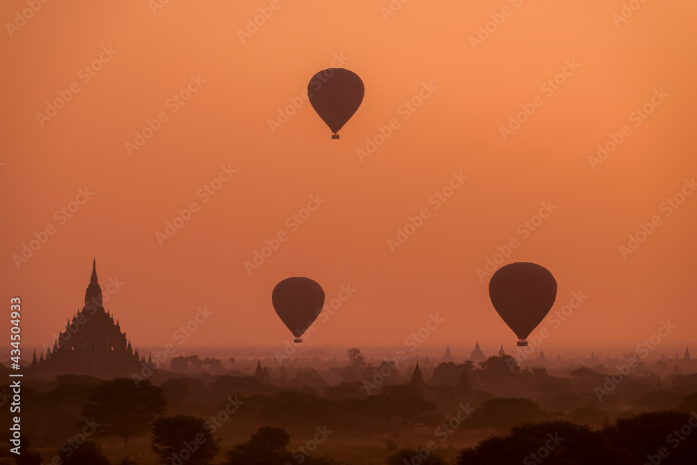 Hot air balloons fly low over Sulamani temple in Bagan, Myanmar at sunrise. Hot air balloons fly low over Sulamani temple in Bagan, Myanmar at sunrise.