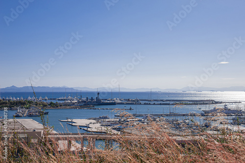 destroier moored with yachts in a bay marina view from above