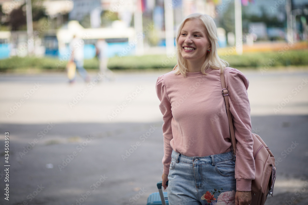 Woman tourist goes on a bus. Smiling tourist woman.