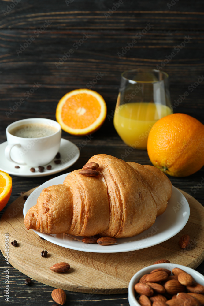 Concept of tasty breakfast with croissant on wooden background Concept of tasty breakfast with croissant on wooden background