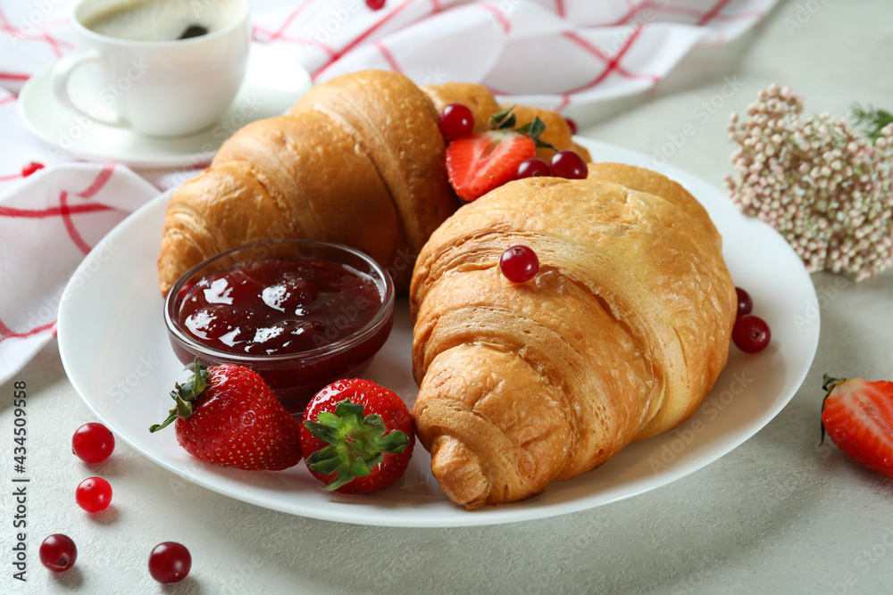 Concept of tasty breakfast with croissants on white textured table Concept of tasty breakfast with croissants on white textured table