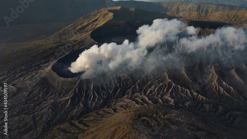 Mount Bromo is smoky active volcano with crater. Aerial view of Mount Bromo volcano (Gunung Bromo) in East Java, Indonesia. © puhhha