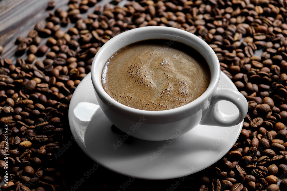 Coffee cup and coffee beans. Copy space. Espresso or Americano in a cup. Coffee beans background Coffee cup and coffee beans. Copy space. Espresso or Americano in a cup. Coffee beans background