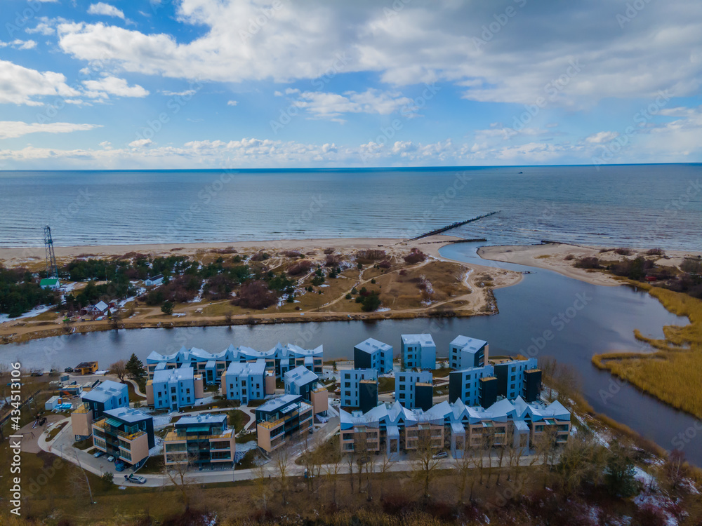 Aerial view of Sventoji resort on the coastline of Baltic sea in Lithuania. City panorama with port and new residential area in it