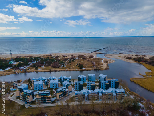 Aerial view of Sventoji resort on the coastline of Baltic sea in Lithuania. City panorama with port and new residential area in it © Audrius
