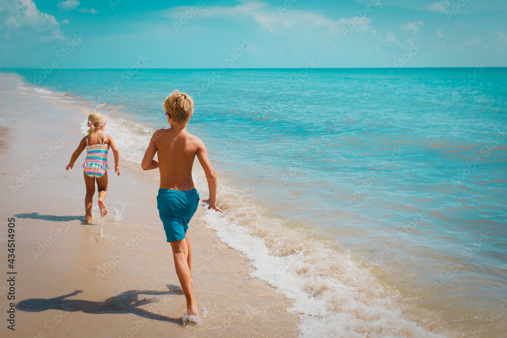 kids run, boy and girl have fun on tropical beach