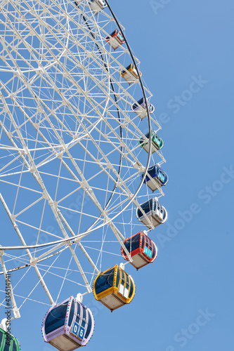 openwork Ferris wheel in the park stands