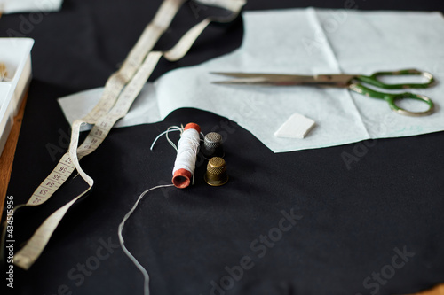 Top view of Sewing supplies on a wooden table photo