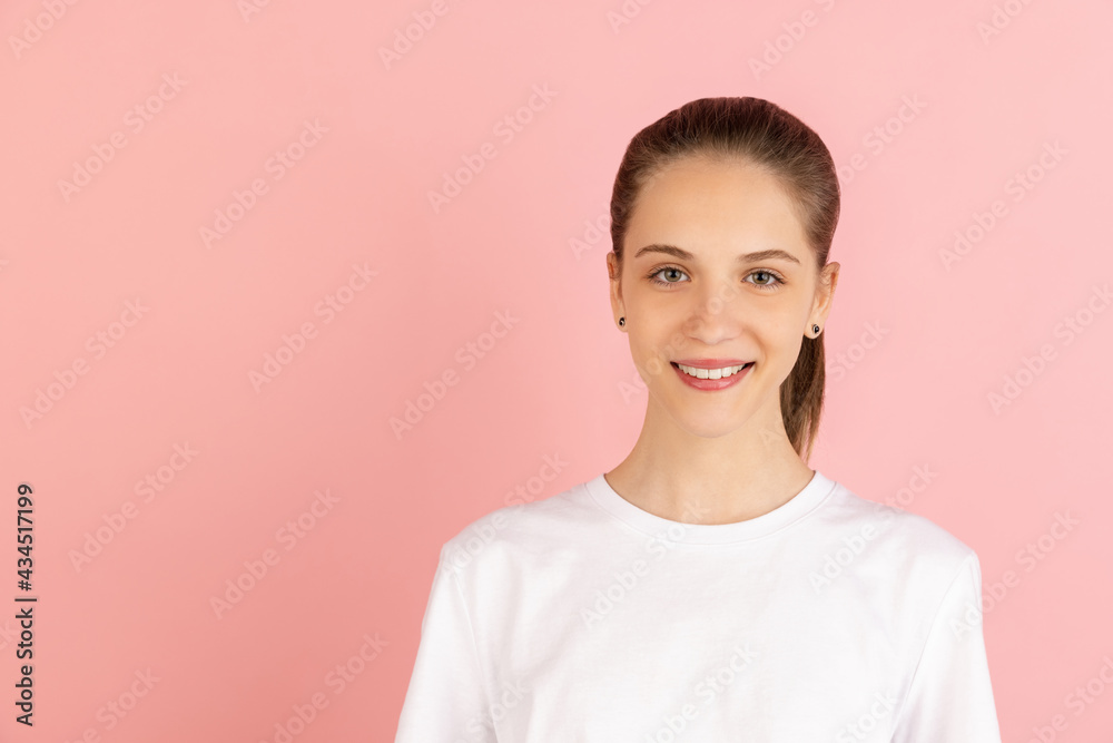 Caucasian young woman's portrait isolated over pink studio background with copyspace Caucasian young woman's portrait isolated over pink studio background with copyspace