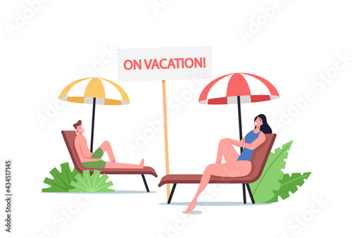 Young Man and Woman Lounging on Chaise Lounge under Sun Rays Relaxing on Sea Beach at Summer Time Vacation Holidays
