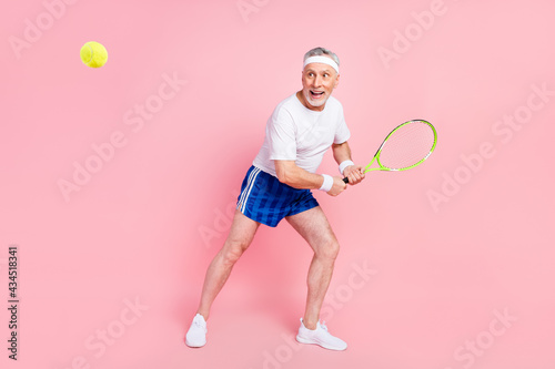 Full length body size photo grandpa threw ball with racket on championship playing tennis isolated pastel pink color background © deagreez