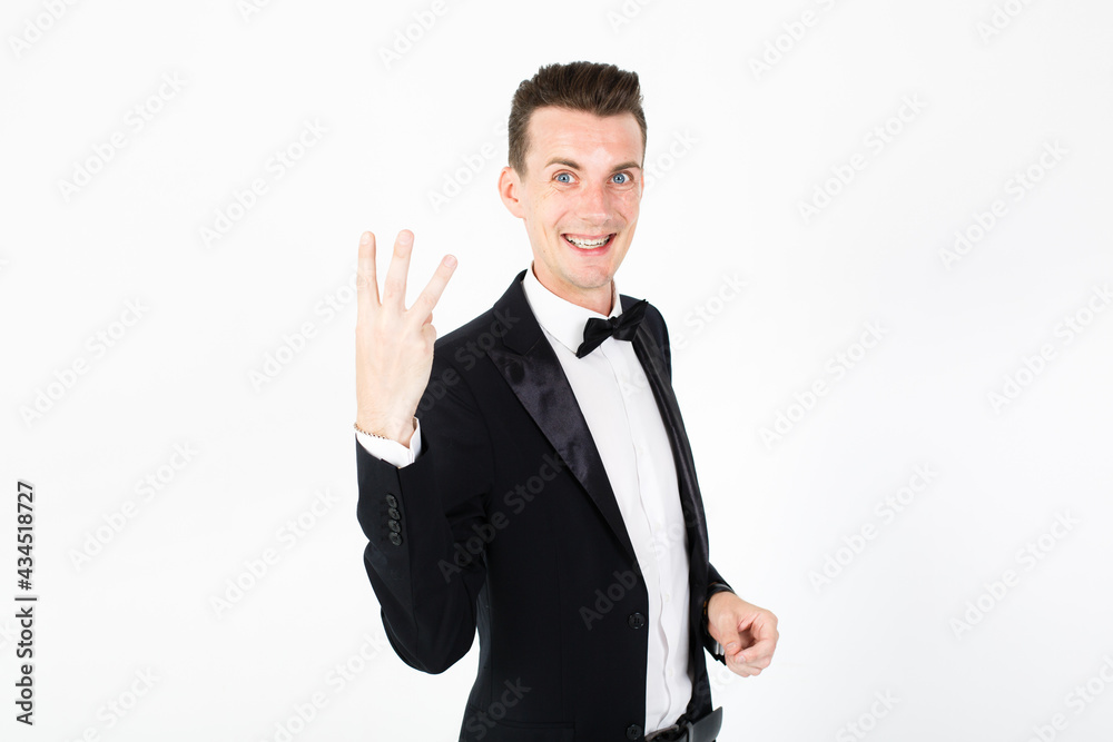 Man toastmaster points on something. Young man master performing on the stage. Man on white background with copy space Man toastmaster points on something. Young man master performing on the stage. Man on white background with copy space