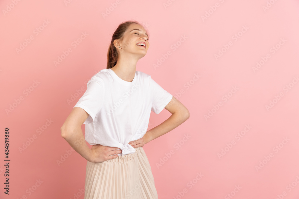 Caucasian young woman's portrait isolated over pink studio background with copyspace Caucasian young woman's portrait isolated over pink studio background with copyspace