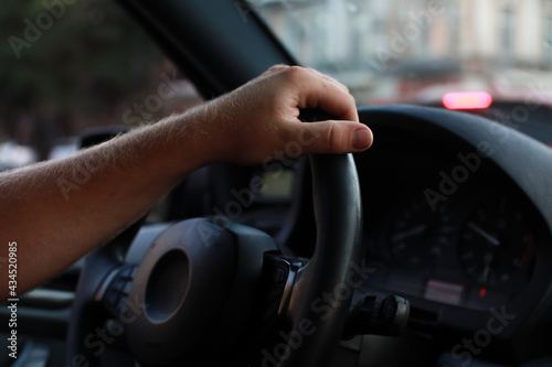 Wallpaper Mural A man drives a car. Hand and steering wheel. Dark leather interior. Torontodigital.ca