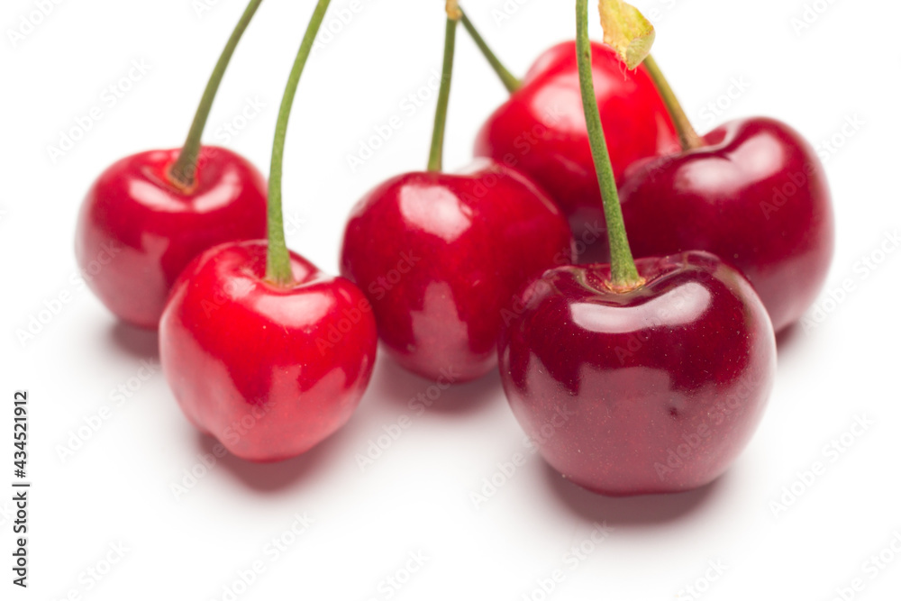 Small red cherries on a white background Small red cherries on a white background