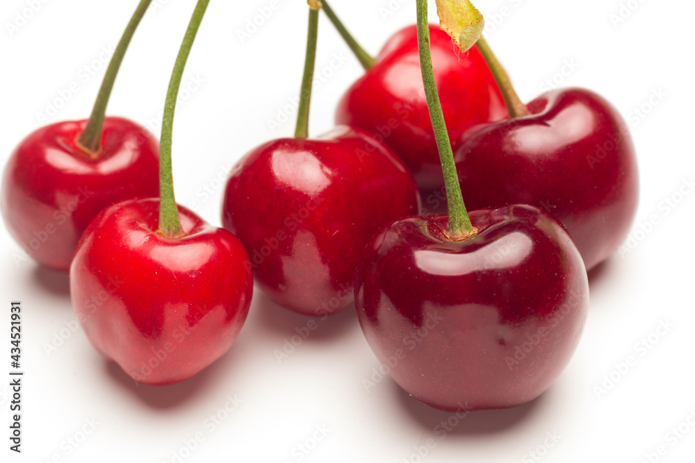 Small red cherries on a white background