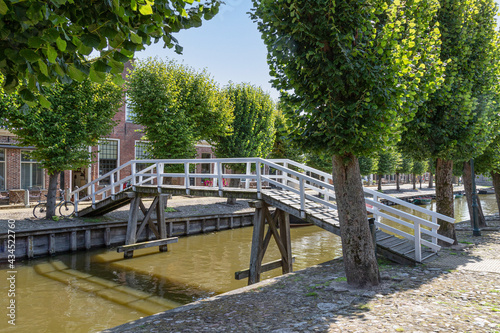 A wooden white bridge over the canal in the picturesque town of Sloten in the Netherlands