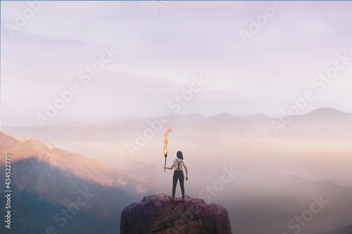 woman on top of a mountain with a torch, concept of success © Cristina Conti