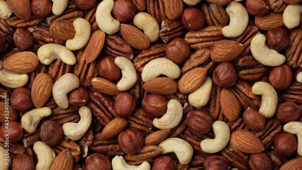 Mix nuts cashews, almonds, hazelnuts top view. Sliding shot. 4K UHD video Mix nuts cashews, almonds, hazelnuts top view. Sliding shot. 4K UHD video