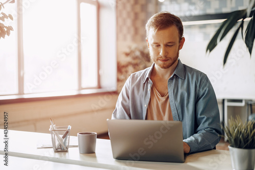 Young businessman working on computer in the office