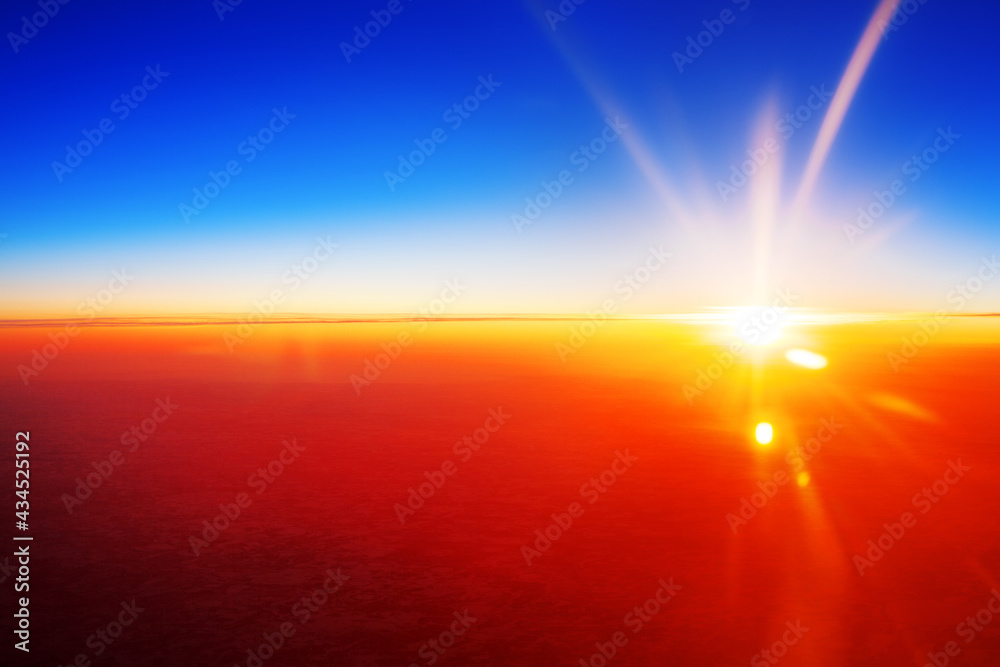 Sunset landscape, colorful sunrise over planet Earth, blue sky, bright yellow sun light rays, red sunbeams, vibrant cosmic sunlight flare, space dawn, cosmos sundown, celestial body view from airplane