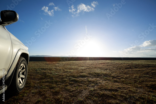 Driving offroad car on trail in high altitude grassland photo