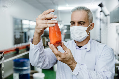 Quality control and food safety inspector test and check product contaminate standard in the food and drink factory production line with hygiene care.