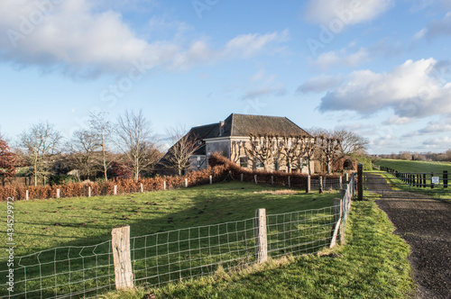 farmhouse in the wide, open polder near river IJssel