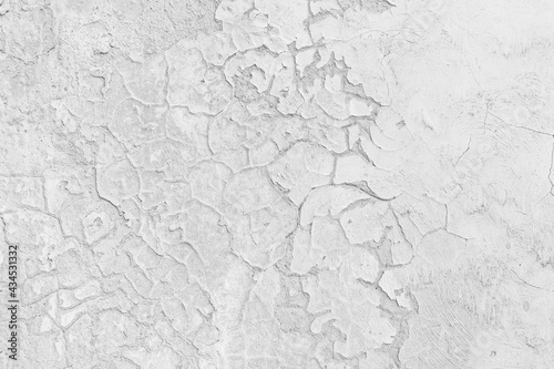 Old rustic grungy aged painted simple bleached facade. Rough edged wall. Wrinkled uneven flaked plastering. Cracked chipped bumpy falling stucco. Bright vintage flaking textured layer for 3D design