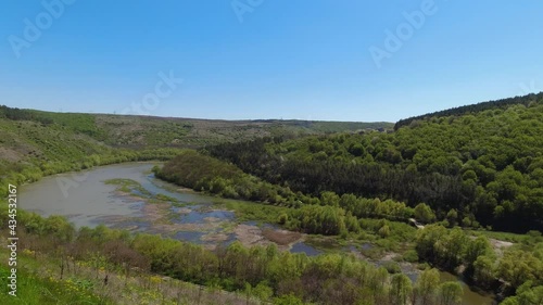 Panoramic, slow-motion view from above on the Ternava river and canyon of national nature park Podilski Tovtry photo