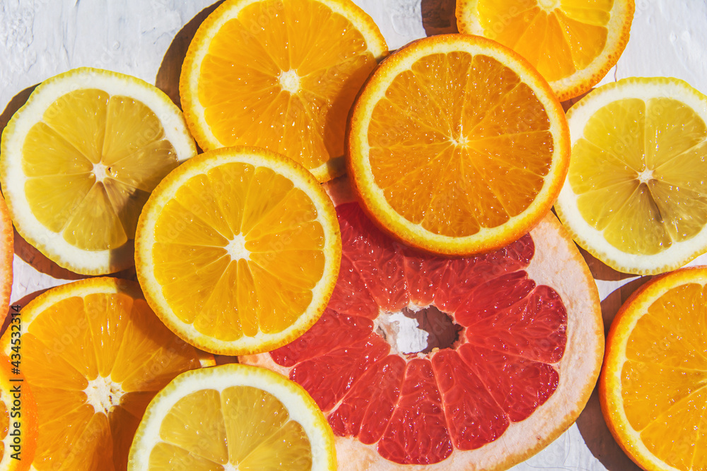 Obraz premium Citrus fruits. Orange, lemon, grapefruit, on a trendy stone background Top view, flat lay