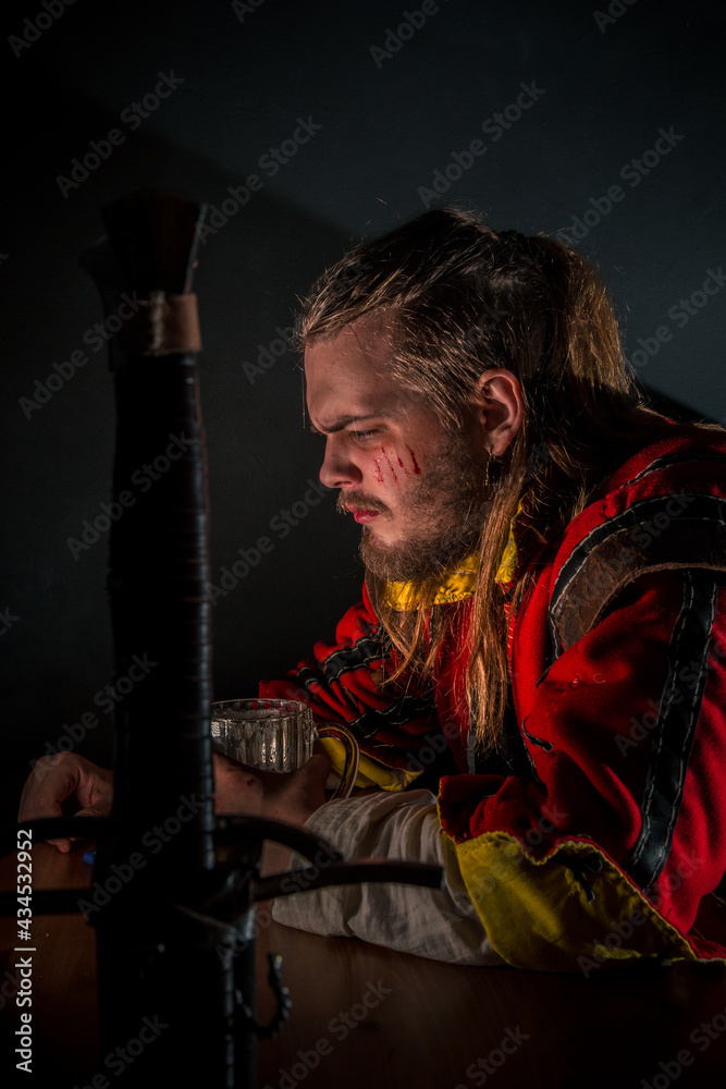 Fototapeta premium Witcher in a bar with smoke drinking beer
