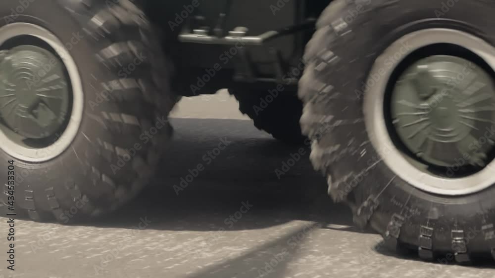 Close-up of rubber tires of a moving armored personnel carrier at a military parade. Close-up of rubber tires of a moving armored personnel carrier at a military parade.