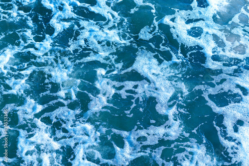Deep blue and rough sea with lot of sea spray.Blue background.Soft focus,blurred image.